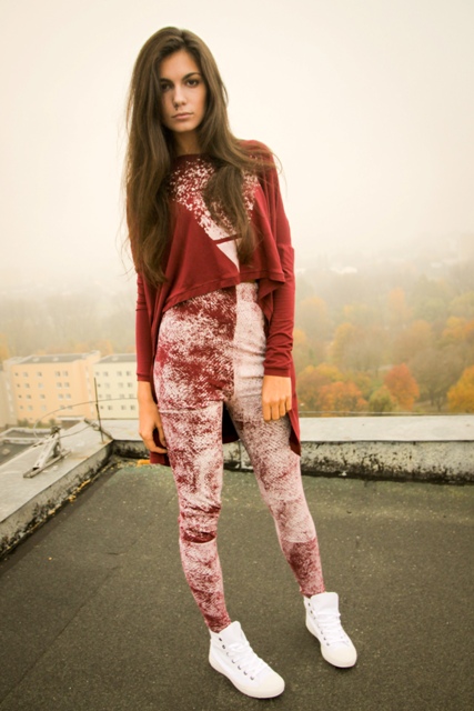 Model on a rooftop in a burgundy printed jersey top and leggings
